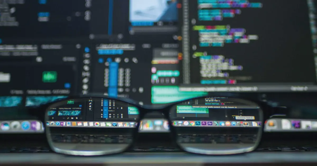 Black framed eyeglasses in front of laptop computer - FI