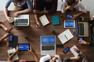 Top view photo of people near wooden table - tn