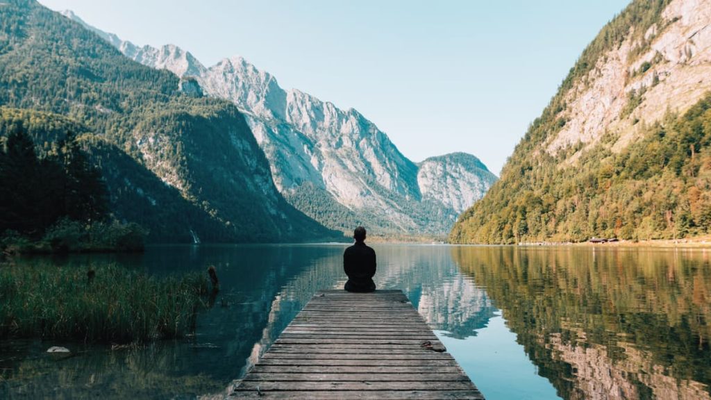 Blog - A person sitting on wooden planks across the lake scenery 747964 - FI