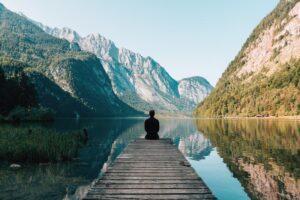 Blog - A person sitting on wooden planks across the lake scenery 747964 - TN