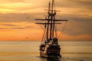 A pirate ship sailing on sea during golden hour 37730 - TN