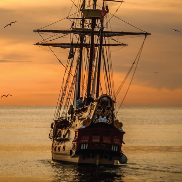 A pirate ship sailing on sea during golden hour 37730 - Infographic